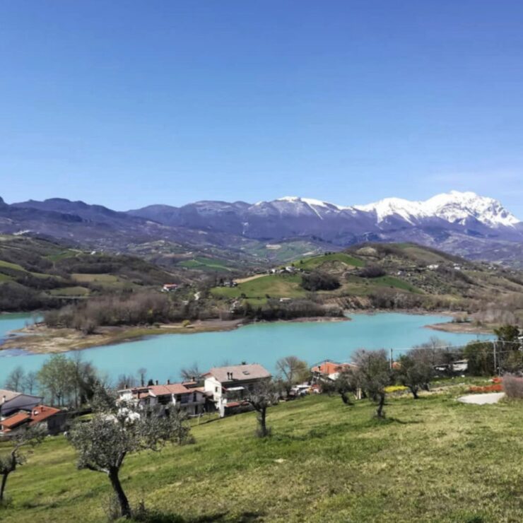 Lago di Penne nature reserve with turquoise water and Gran Sasso mountains Pescara Abruzzo Italy