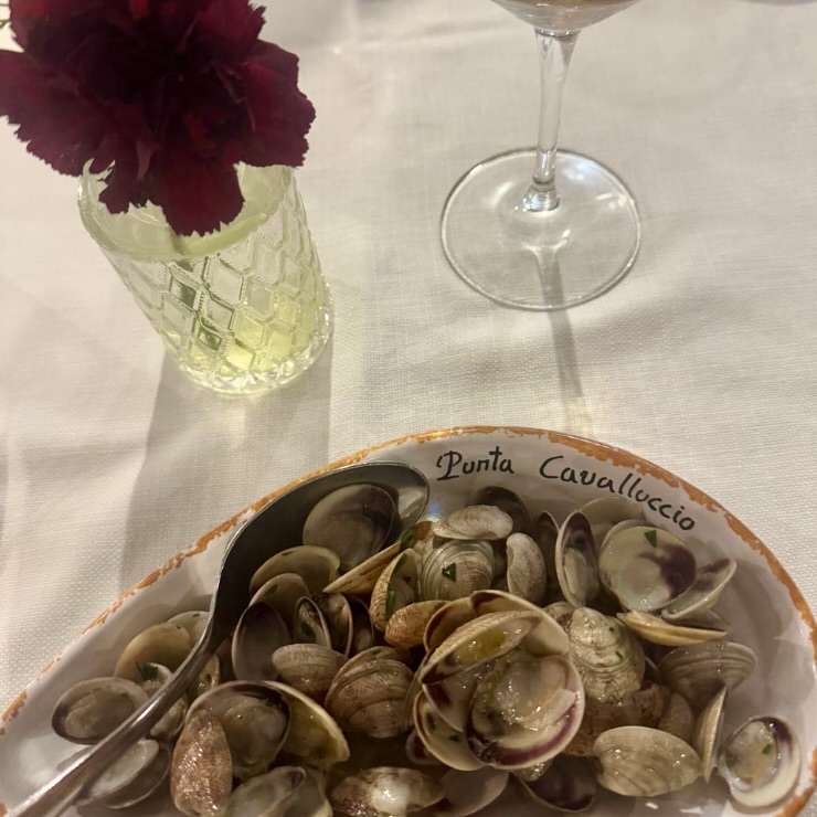Fresh clams in Punta Cavalluccio branded bowl at trabocco restaurant Costa dei Trabocchi Abruzzo Italy
