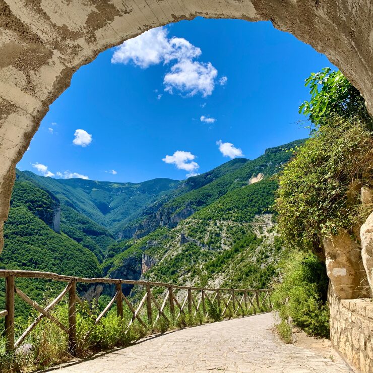 Stone arch at the start of the Gobbe di Selvaromana trail Belvedere Balzolo Pennapiedimonte with views over Valle dell'Avello Abruzzo