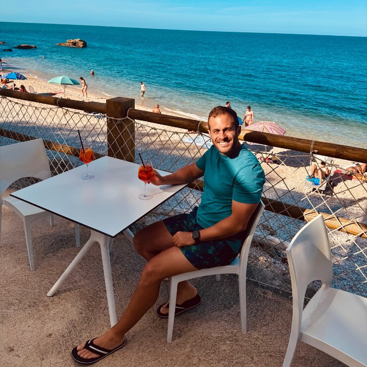 Aperol Spritz overlooking Ripari di Giobbe beach Abruzzo Italy at sunset Costa dei Trabocchi