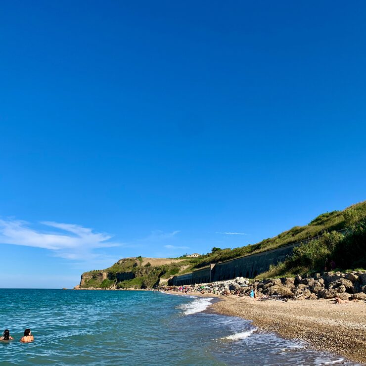 Path along Punta Ferruccio beach Abruzzo Italy with turquoise Adriatic Sea and rocky shoreline