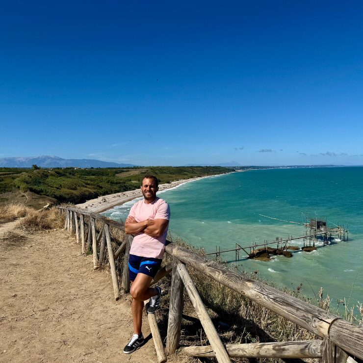 Panoramic view of Punta Aderci nature reserve Abruzzo Italy with turquoise Adriatic Sea trabocco and La Maiella mountain