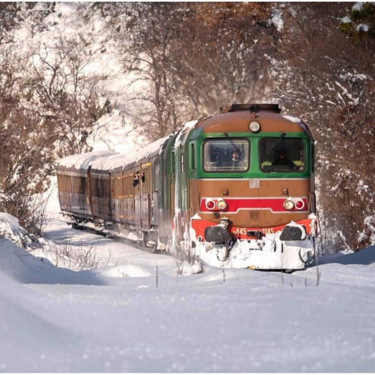 Transiberiana d'Italia historic train through snow covered Abruzzo landscape winter