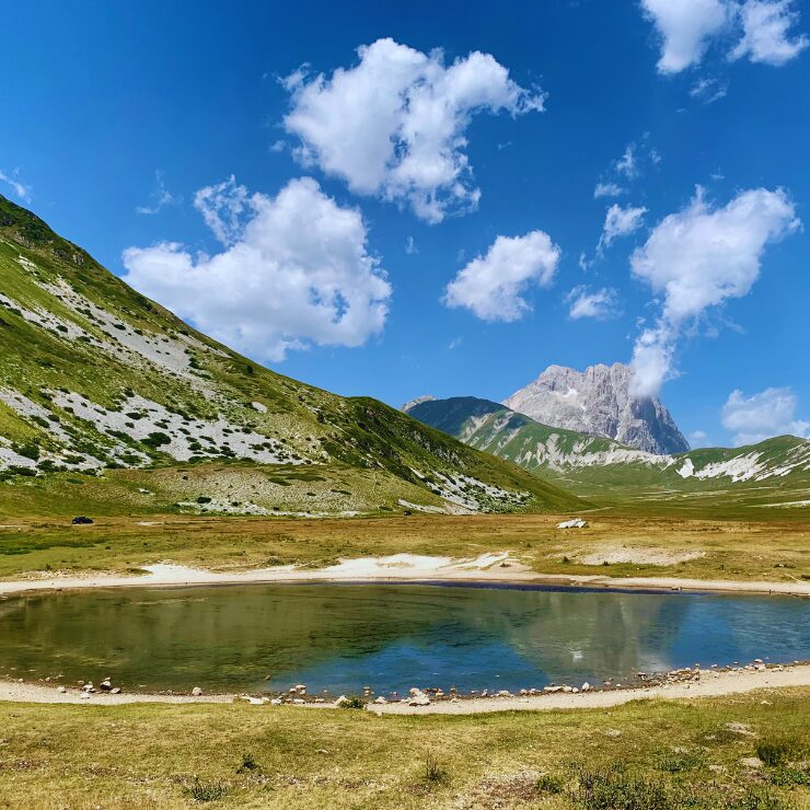 Campo Imperatore plateau with mountain lake and Corno Grande peak Gran Sasso Abruzzo Italy