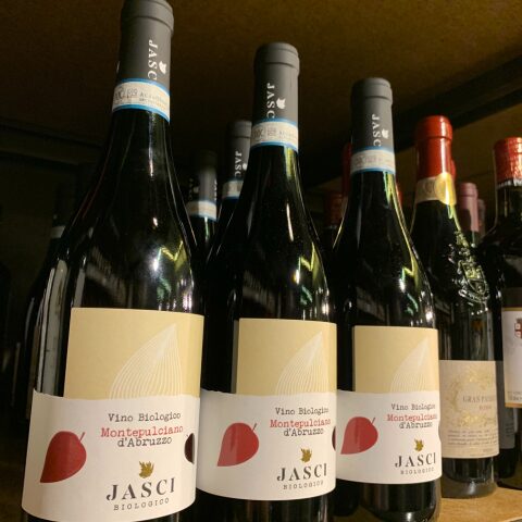 Three bottles of Jasci Biologico Montepulciano d'Abruzzo organic red wine lined up on a shelf