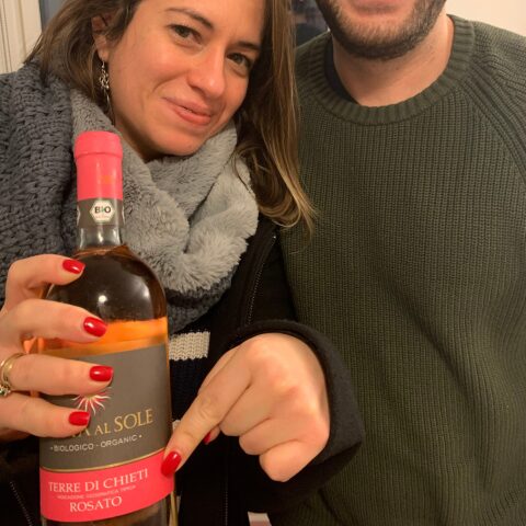 Two people holding up a bottle of Terra al Sole organic Rosato from Terre di Chieti, Abruzzo
